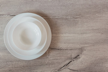 Empty white blank plate on wooden background with copy space. Top view.