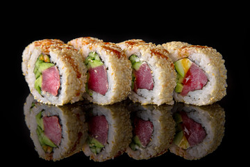 Sushi roll (Maguro) with tuna, shrimp, salmon, smoked eel, avocado, philadelphia cheese on black background. Sushi menu. Japanese food.