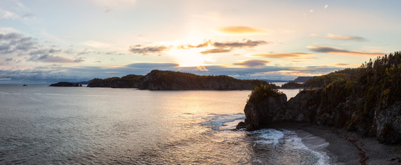 Striking panoramic landscape view of a rocky Atlantic Ocean Coast during a vibrant sunrise. Taken at Beachside, Newfoundland and Labrador, Canada.