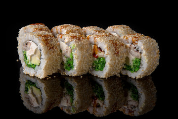 Sushi roll with smoked eel, chukka salad, avocado, philadelphia cheese on black background. Sushi menu. Japanese food.