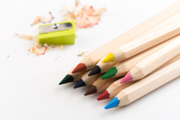 Fototapeta premium Wooden colorful pencils isolated on a white background, pencil sharpeners.