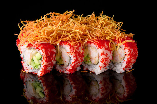 Sushi (Captain Crunch) roll with shrimp, avocado, philadelphia cheese  on black background. Sushi menu. Japanese food.