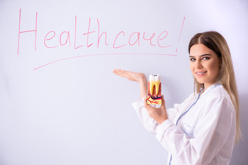 Young female doctor standing in front of the white board