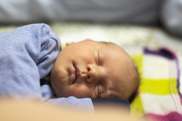 Fototapeta na wymiar newborn baby lying on the bed close-up