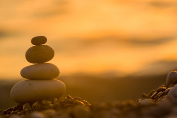 stack of zen stones on pebble beach