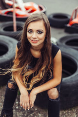 Fototapeta na wymiar Close up portrait of cute extremal girl on street racing. Speed, hobby, lifestyle, beauty concept