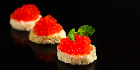 red caviar (canapés or a red snack sandwich). food background. top view