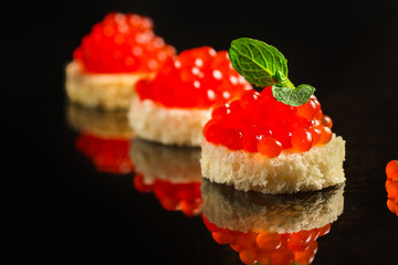 red caviar (canapés or a red snack sandwich). food background. top view