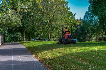 Council motorized grass cutter in park