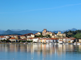 Fototapeta na wymiar San Vicente de la Barquera reflected in water, coastal village in Cantabria, Nothern Spain