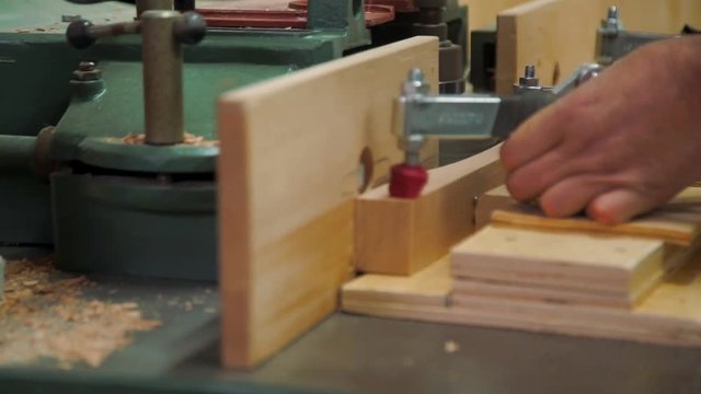 Milling in a wooden beam.Video footage of wood processing. circumcision is unnecessary from a piece of wood