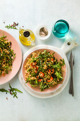 rice salad with baked bell peppers, arugula, olives and capers. Healthy vegan spring recipe for the whole family or party
