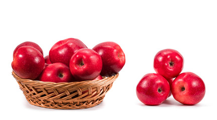 Ripe red apple in wicker basket isolated on white