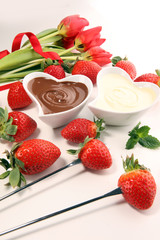 Valentine Chocolate fondue melted with fresh strawberries and dark and white chocolate. Tublips and sugar hearts.