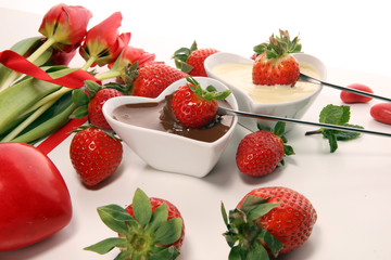 Valentine Chocolate fondue melted with fresh strawberries and dark and white chocolate. Tublips and sugar hearts.