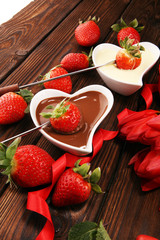 Valentine Chocolate fondue melted with fresh strawberries and dark and white chocolate. Tublips and sugar hearts.