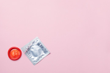 condom on pink background, safe sex concept, copy space.