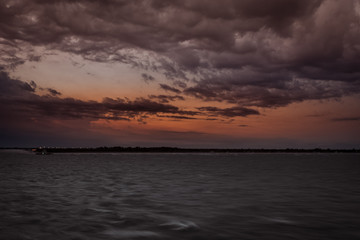 Fototapeta premium Panorama of Punta Sabbioni lighthouse in the Venice lagoonduring a thunderstorm