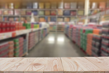 Empty wooden board table top on of blurred supermarket background. with copy space for display or montage your products