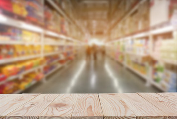 Empty wooden board table top on of blurred supermarket background. with copy space for display or montage your products