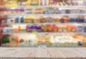 Empty wooden board table top on of blurred supermarket background. with copy space for display or...