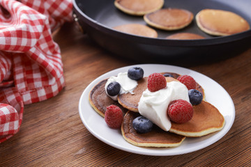 pancakes with berries on a plate