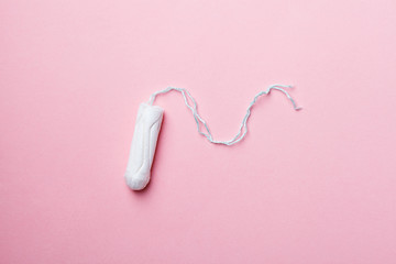 cotton tampon on pink background, flat layout, top view