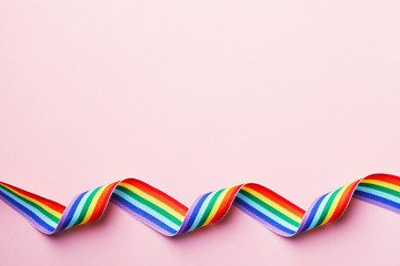 LGBT rainbow ribbon on pink background
