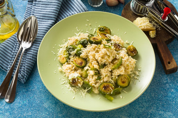 Italian spring risotto with Brussels sprouts and parmesan cheese on the table. healthy food for the whole family, party or restaurant menu