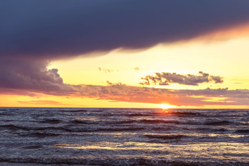 Fototapeta premium Seashore and waves at sunset. Calmness, awareness, the path to yourself. Harmony and life without stress