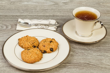 Cup of Tea with Oatmeal and Raisin Cookies on Elegant China