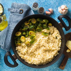 Italian spring risotto with Brussels sprouts and parmesan cheese on the table. healthy food for the whole family, party or restaurant menu