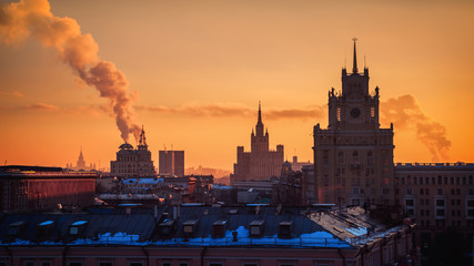 Obraz premium Moscow, Russia Sunset Orange Sky Calm Winter Landscape Towers Old Architecture Travel Location Smoke Stack European