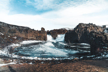 Famous Hjalparfoss double waterfall in southern Iceland with sky and clouds. treking in Iceland....