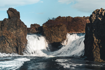 Famous Hjalparfoss double waterfall in southern Iceland with sky and clouds. treking in Iceland. Travel and landscape photography concept