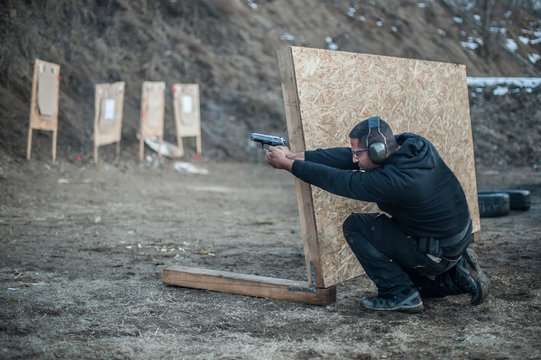 Combat gun tactical shooting behind and around cover or barricade