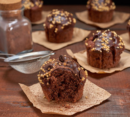 chocolate muffins on a brown wooden background