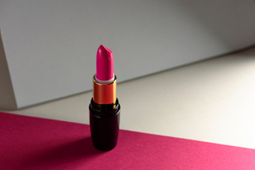 Pink lipstick on modern background. Product and make up concept