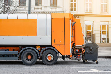 Garbage disposal lorry at city street. Waste dump truck on town road. Municipal and urban services....