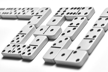 A row of domino stones on a light background