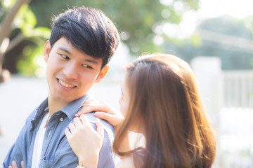 Beautiful portrait couple looking each others eyes and smiling with happy, young asian man and...