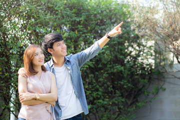Beautiful portrait couple looking each others eyes and smiling with happy, young asian man and...