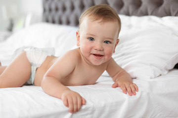 Adorable little baby on bed at home