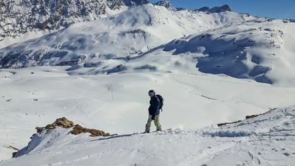 Alps Skiing Snowboarder in Backcountry with backpack