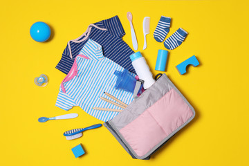 Flat lay composition with baby accessories and maternity bag on color background