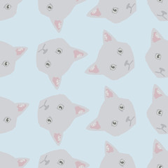 Cute vector pattern of kitties heads on blue background. Seamless illustration of pretty animal portraits.