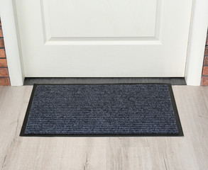 New clean mat near entrance door. Household item