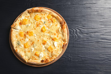 Hot cheese pizza Margherita on wooden table, top view. Space for text