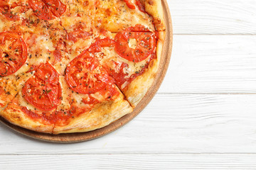 Hot cheese pizza Margherita on white wooden background, top view. Space for text