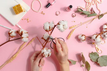 The girl collects a bouquet of dried and fresh flowers. Ikebana. Top view.